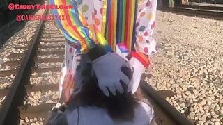 Clown almost gets hit by train while getting blowjob