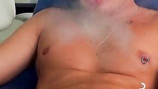 Handsome blonde explores his ass while blowing smoke