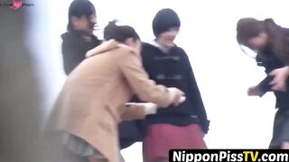 NipponPissTV.com - Kinky schoolgirls from Japan hold each other and pee outside openl