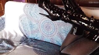 On a sofa wearing ebony goddess platform boots over the