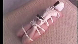 Hogtied Ashley struggling on the floor