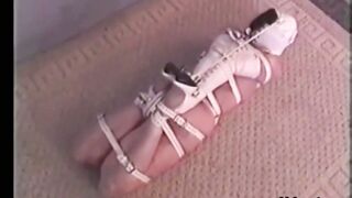 Hogtied Ashley struggling on the floor