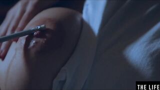 Rubbing her long puffy nipples as she fucks herself with