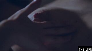 Rubbing her long puffy nipples as she fucks herself with
