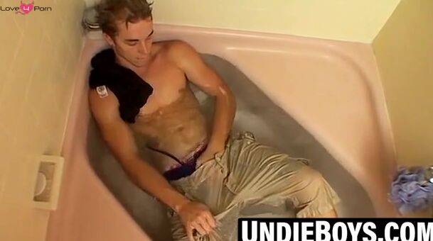 Muscular jock playing with cock during steamy bath