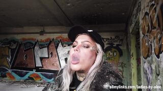 Blonde Lady Smokes An Electric Cigarette On Stairs