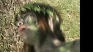 Naked Woman Covered in Mud Sucks Cock Against Tree in Italian Hardcore Movie