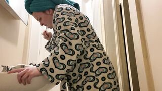 Brunette in Patterned Robe Brushing Teeth at Bathroom Sink