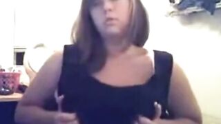 Brunette Girl Strips Top to Show Big Boobs in Bedroom
