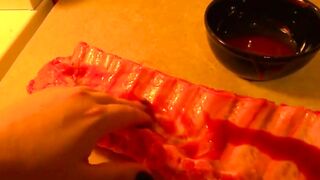 Rubbing the pig like he is a piece of meat