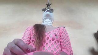 Wearing pink fishnet catsuit and pink platform ankle boots. Hard