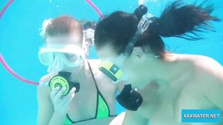 Underwater lesbians lick and suck vibrators