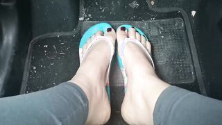 Nicoletta's cute little toes into flip-flops press on the pedals