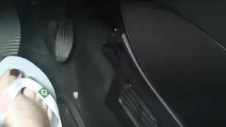 Nicoletta's cute little toes into flip-flops press on the pedals