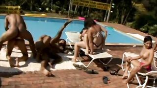 Group of men and Latinas boned by pool