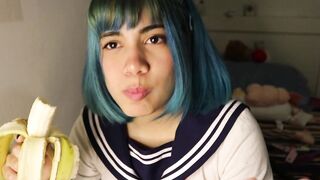 Deep throat: schoolgirl slips a whole banana inside her mouth.