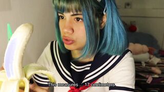 Deep throat: schoolgirl slips a whole banana inside her mouth.