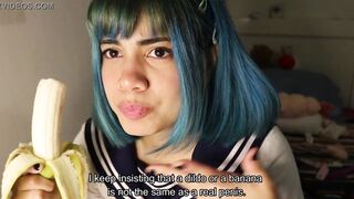 Deep throat: schoolgirl slips a whole banana inside her mouth.