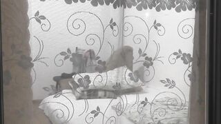 Peeping through windows. Voyeur. Into evening, on street random passerby