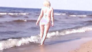 babe milf into a white bikini on the beach