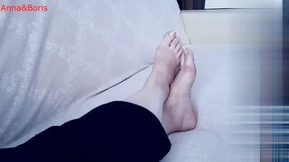 For comfort, Anna sits barefoot on the sofa - one