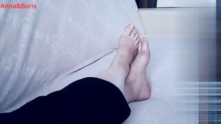 For comfort, Anna sits barefoot on the sofa - one