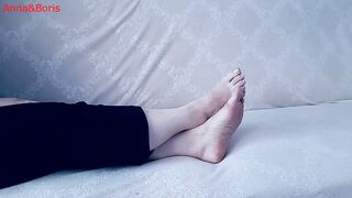For comfort, Anna sits barefoot on the sofa - two