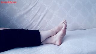 For comfort, Anna sits barefoot on the sofa - two