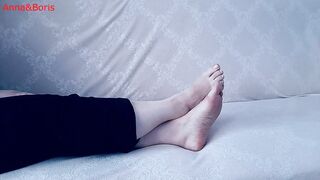 For comfort, Anna sits barefoot on the sofa - two