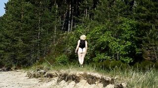 By the beach inside a nylon bodysuit I twist a long ass
