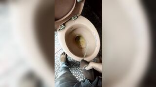 Indian boy pissing in toilet