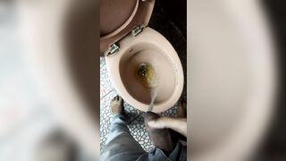 Indian boy pissing in toilet
