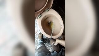 Indian boy pissing in toilet