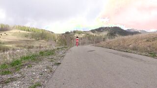 Older MILF with nude charms walks on a outdoors road