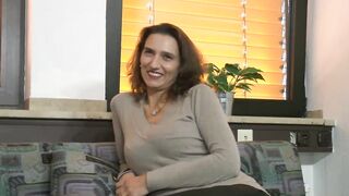 Happy and smiling Bae dark haired german MILF gets up and dildoes her snatch while she massage her tiny boobies