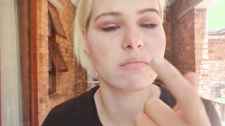 Close up see of pale blonde picking, sucking her nose, snot play