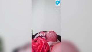 View nasty Susi lying on back having fun with vibrator between boobs
