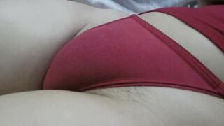 She lays inside her tight red lingerie on her puffy snatch and I squeeze her unshaved Cameltoe until she takes her lingerie off
