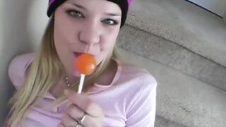 sexy blonde licking candy tease with long boobies closeup