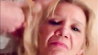 Blonde granny is taking a cumshot on her eyes