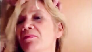 Blonde granny is taking a cumshot on her eyes