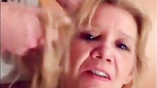 Blonde granny is taking a cumshot on her eyes