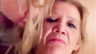 Blonde granny is taking a cumshot on her eyes