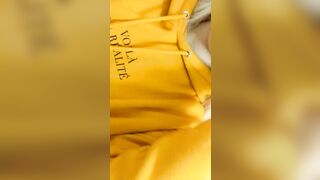 Home daytime striptease into a yellow hoodie. Close-up
