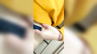 Home daytime striptease into a yellow hoodie. Close-up