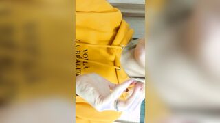 Home daytime striptease into a yellow hoodie. Close-up
