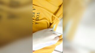Home daytime striptease into a yellow hoodie. Close-up
