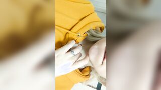 Home daytime striptease into a yellow hoodie. Close-up