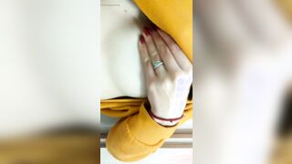 Home daytime striptease into a yellow hoodie. Close-up
