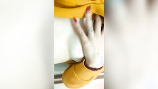 Home daytime striptease into a yellow hoodie. Close-up